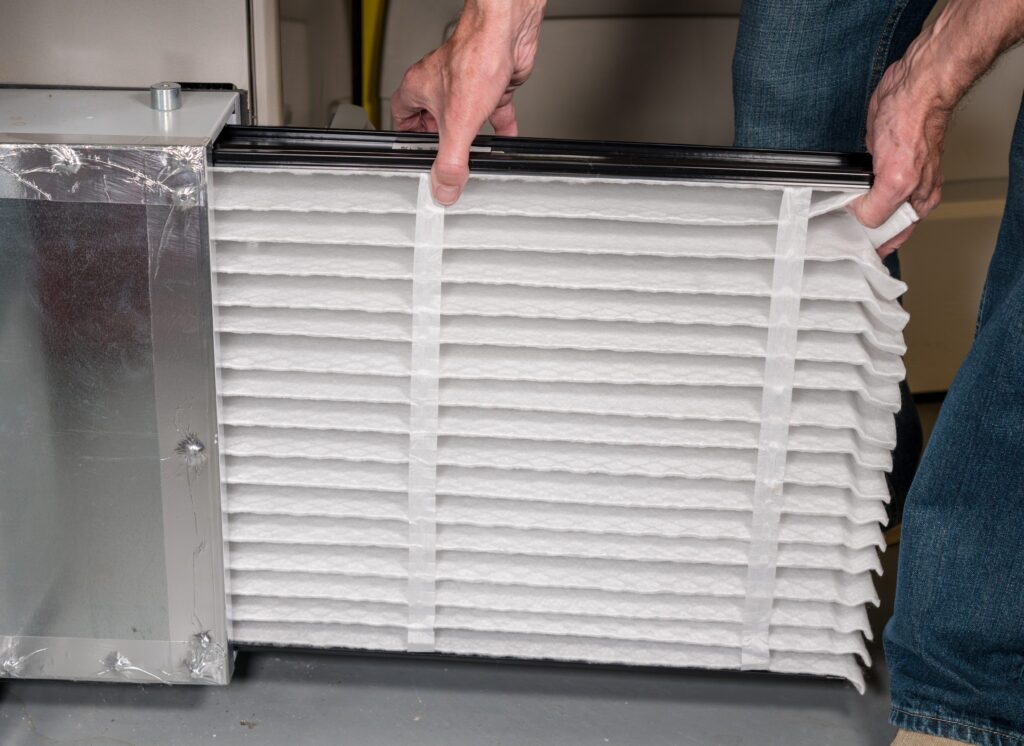 Closeup of technician changing HVAC filter